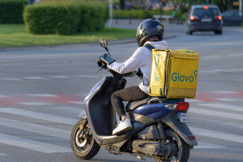 5 - A Glovo delivery courier riding a scooter in Bucharest, Romania